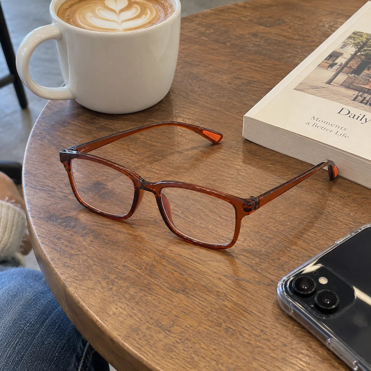Blue-light reading glasses resting on a cafe table