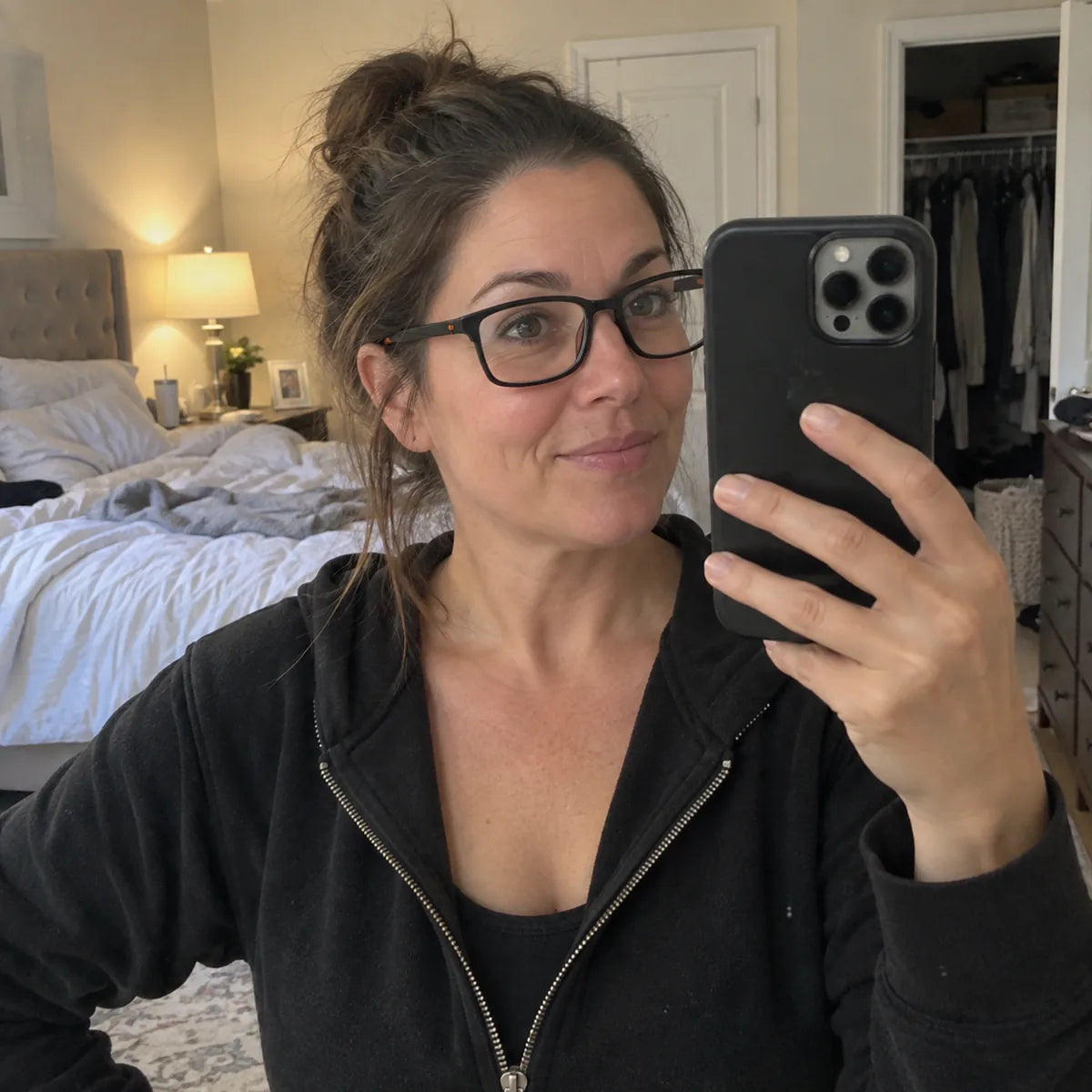 Linda wearing blue-light reading glasses in a mirror selfie