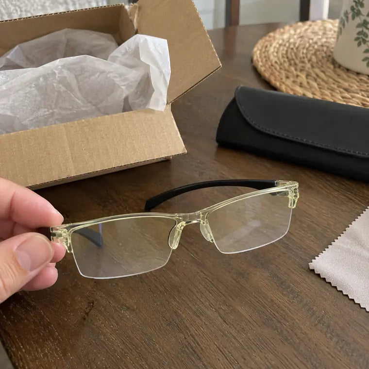 Customer unboxing yellow clear frame glasses with case and cleaning cloth