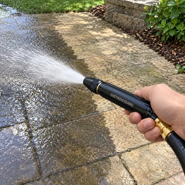 Sprayer nozzle rinsing wet golden retriever